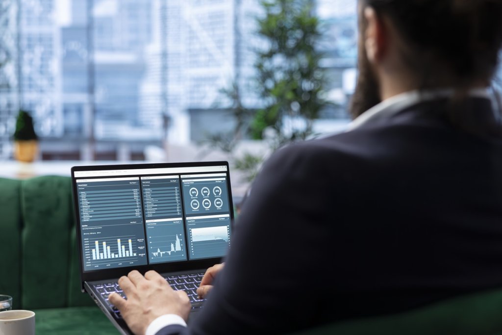 Determined CEO works in office analyzing infographics and setting business goals